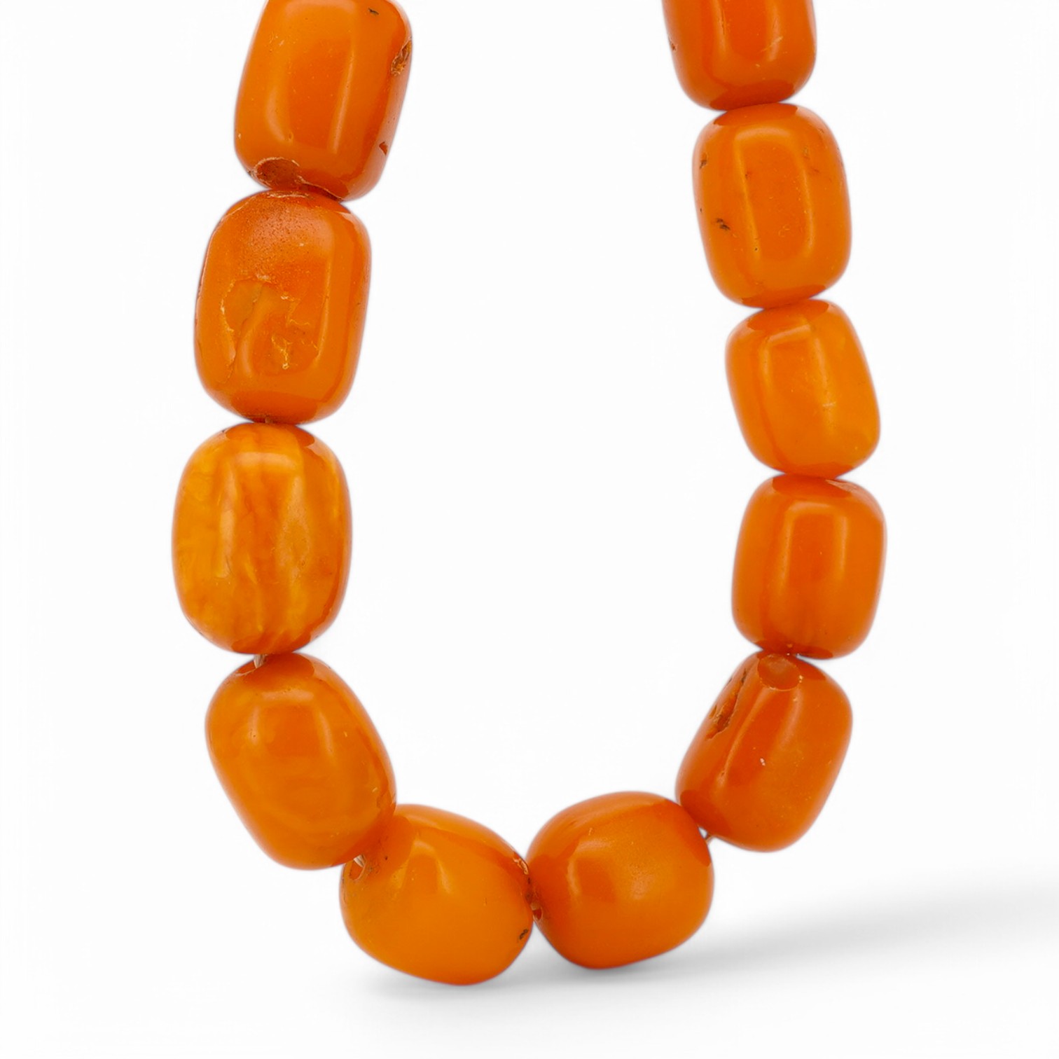 A single strand oval and barrel shaped amber bead necklace, 90cm, gross weight 102 grams. Condition - poor to fair